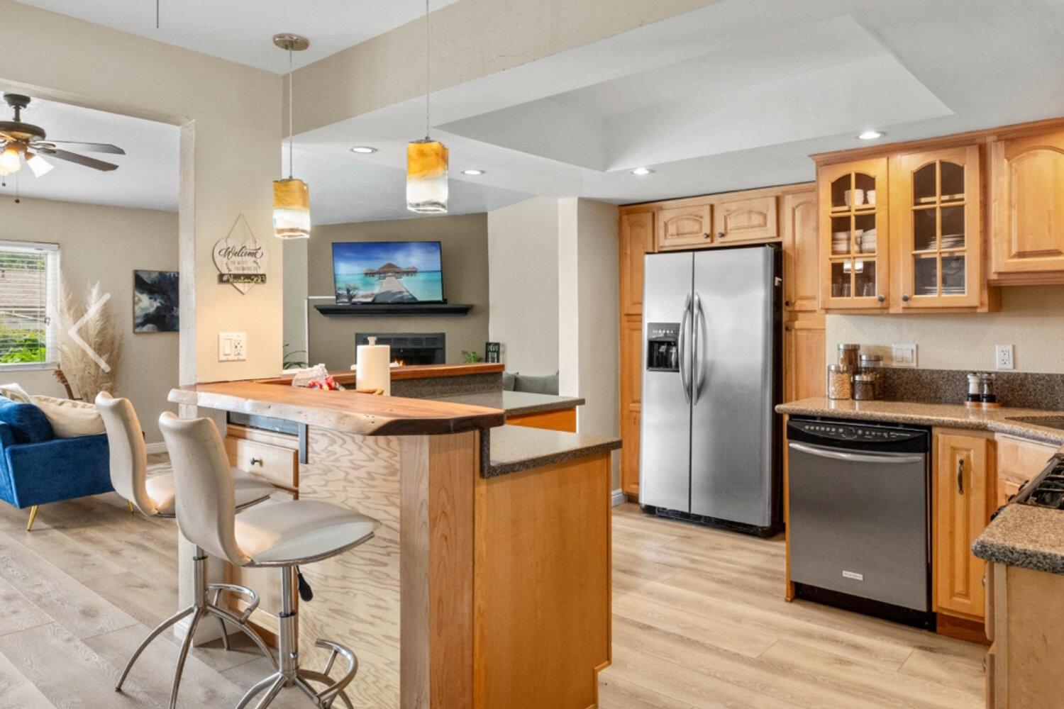 Open plan kitchen and living area with updated lighting